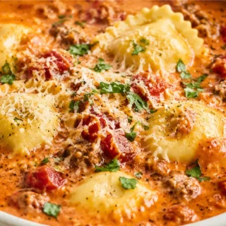 Creamy Ravioli Soup: Comfort in a Bowl - Ravioli Soup: cook this hearty, creamy Italian sausage and tomato soup in one pot. A quick, satisfying weeknight meal f