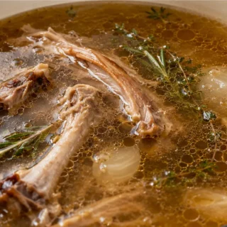 Rich Homemade Turkey Broth - Turkey broth: master this essential recipe from leftover roasted turkey bones. Elevate your gravies and soups with deep, savory fla